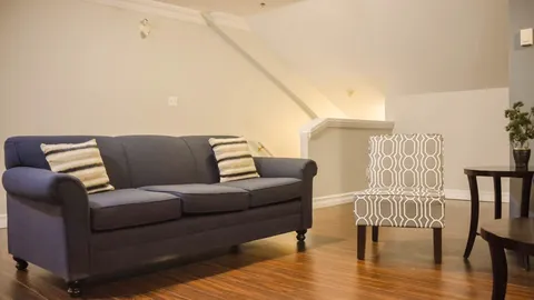 Sitting room with sofas, armchairs and a coffee table.