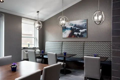 Bistro with tables, booths and pendant lights.