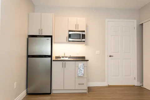 Suite kitchenette with refrigerator and microwave.
