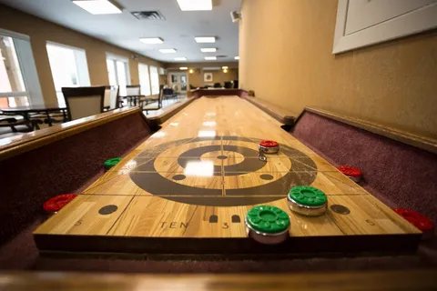 Shuffleboard table in a recreation room.