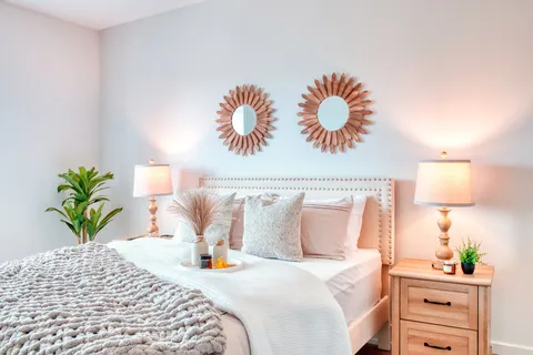 Bedroom with a double bed, bedside cabinets and lamps.