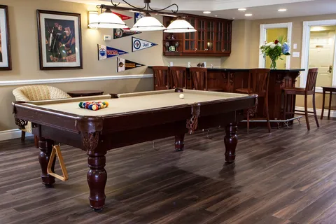 Games room with a billiards table and bar counter.