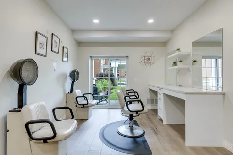 Hair salon with styling chairs, mirrors and hood dryers