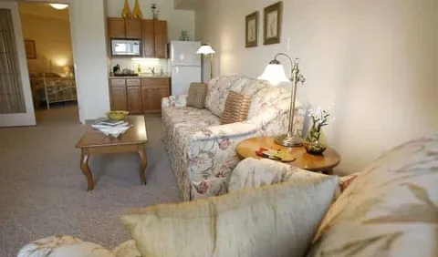 Sitting area with upholstered seating, a coffee table and kitchenette