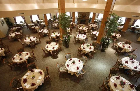 Dining room viewed from above with round tables, chairs and set places