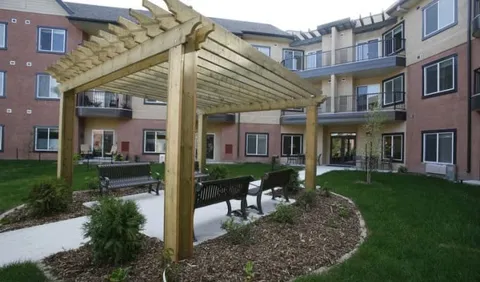 Garden patio with a wooden pergola and curved path