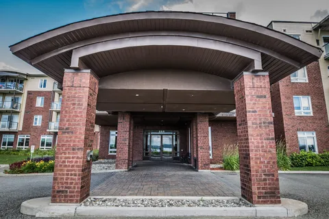 Covered entrance with brick pillars and glass doors