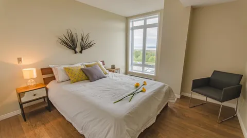 Bedroom with a double bed, bedside tables, an armchair and a window
