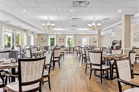 Dining room with tables, patterned chairs and ceiling lights