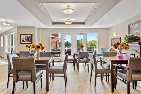 Small dining tables and chairs beside glass patio doors