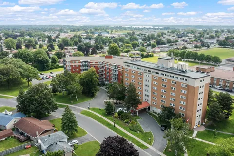 Aerial view of brick residence buildings around a landscaped lawn