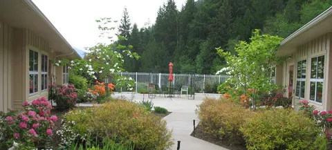 Garden pathway between low-rise residence wings.