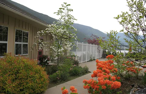 Flower beds and a garden path beside the residence.