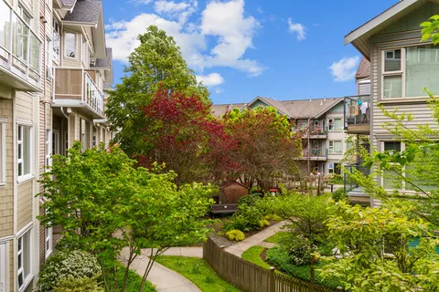 Courtyard with planted flower beds, benches and trees