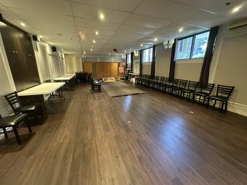 Large recreation room with tables and chairs.