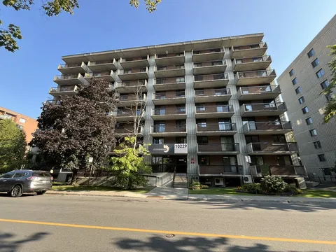 Apartment building with balconies facing the street.