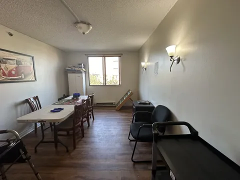 Small sitting room with a table and chairs.