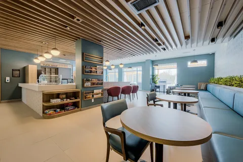 Bistro tables and booth seating beside a counter.