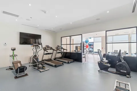 Fitness room with treadmills, exercise bikes and strength equipment.