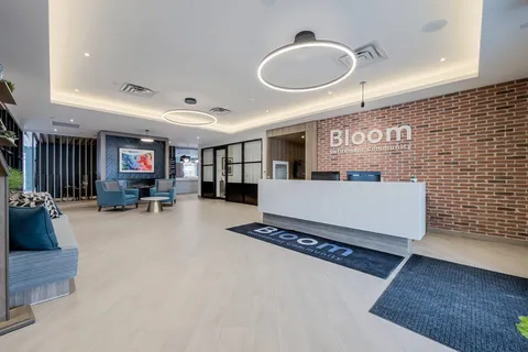 Reception counter and seating beside a brick feature wall.