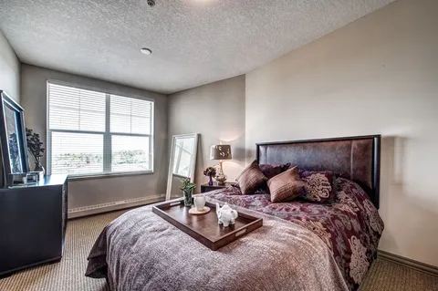 Bedroom with a double bed, bedside tables and a window.