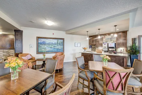 Bistro with dining tables, upholstered chairs and a counter.