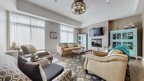 Sofas and armchairs around a fireplace with display cabinets