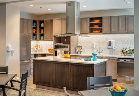 Kitchen with a central island, stainless appliances and cupboards