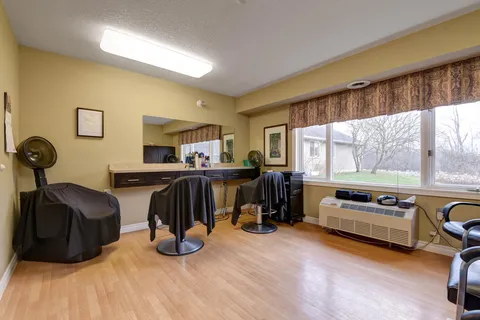Hair salon with styling chairs, mirrors and a large window