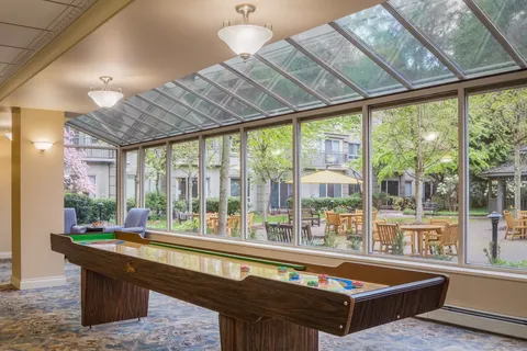 Shuffleboard table beside large windows overlooking a patio