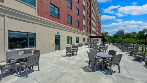 Patio tables and chairs beside the residence building