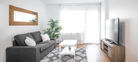 Sitting area with a sofa, coffee table and television