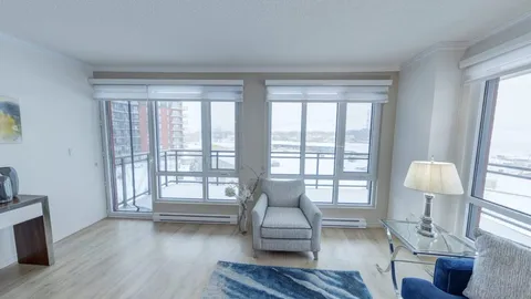 Sitting area with armchairs and a small table beside a window