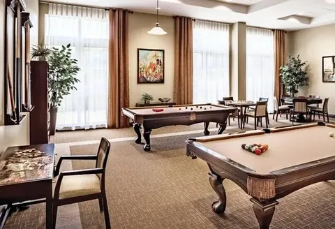 Games room with billiards tables and window seating.