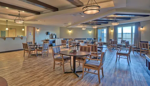Dining room with wooden tables and chairs.