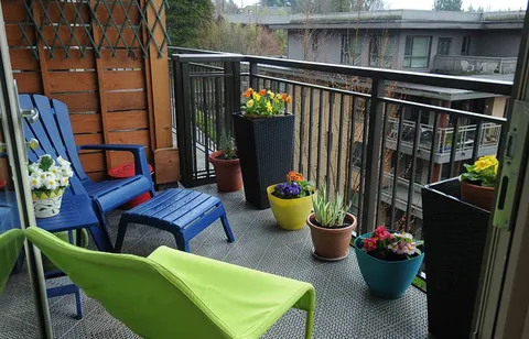 Balcony with colourful chairs and potted flowers