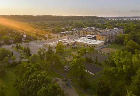 Aerial view of residence buildings and landscaped grounds at sunset