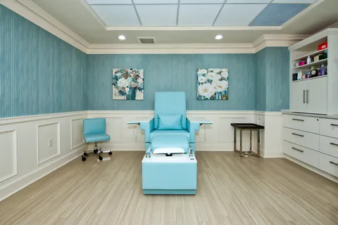 Spa room with a reclining chair and storage cupboards