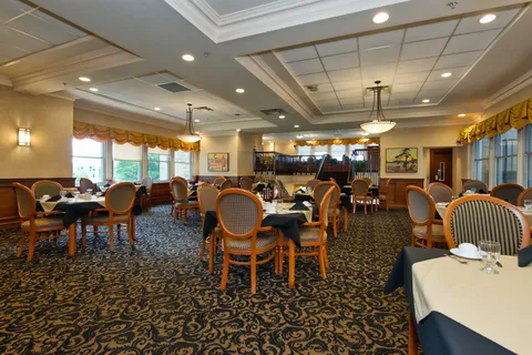 Dining room with set tables beside large windows