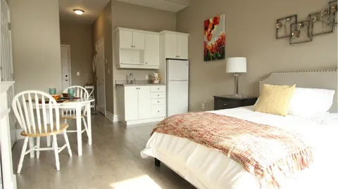 Studio suite with a bed, dining table and kitchenette.