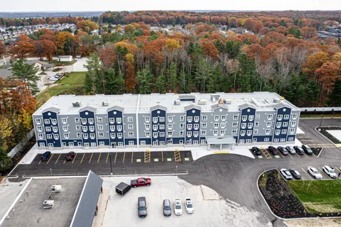 Aerial view of the residence, parking area and trees in autumn colours
