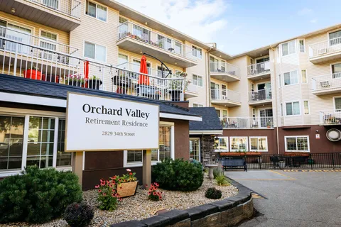 Residence building with balconies, paved paths and a freestanding sign