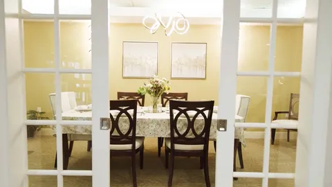 Dining table and chairs viewed through glass-panelled doors