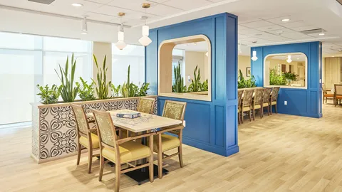 Seating and small tables along a corridor.