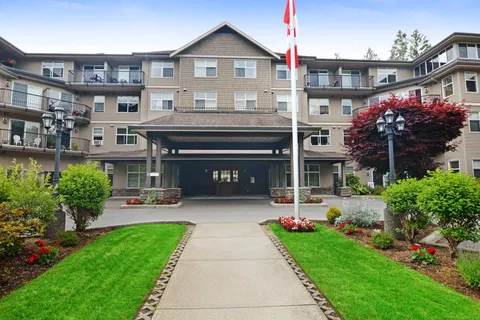 Residence facade with a covered entrance and landscaped grounds