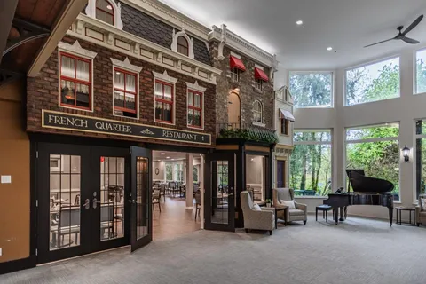 Lobby with a grand piano beside an open dining room entrance