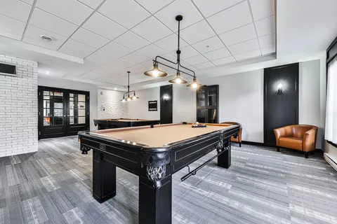 Games room with two billiards tables and leather armchairs