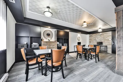 Room with high tables, chairs and computer desks