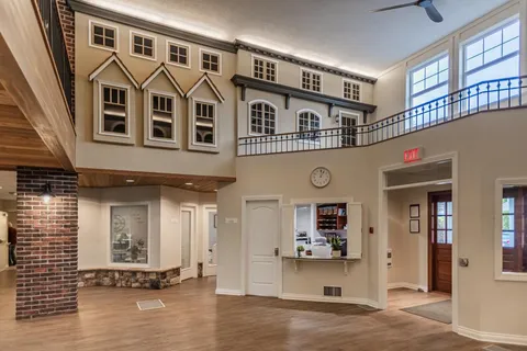 Two-storey lobby with decorative window facades and a reception counter