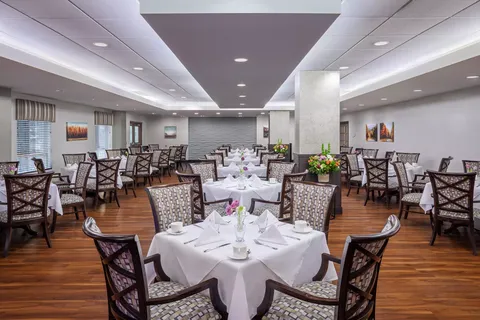 Dining room with white tablecloths and patterned chairs